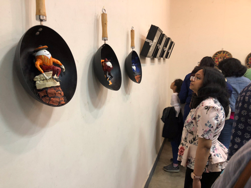 Spiritual Adept Divya looking at exhibits from Humpty Dumpty Meets God by Tarun Cherian